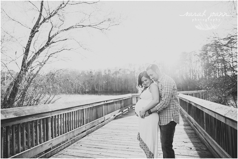 black and white maternity photos on a bridge at yates mill