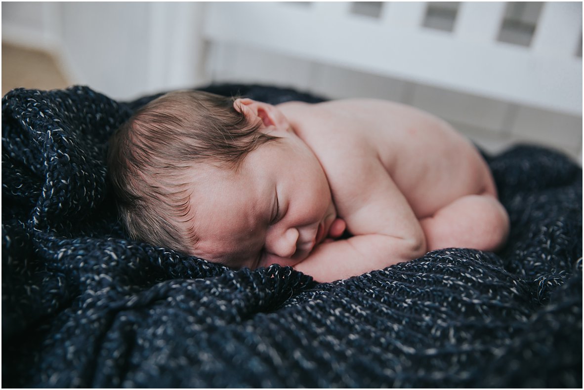 baby boy sleeping on blanket at newborn session