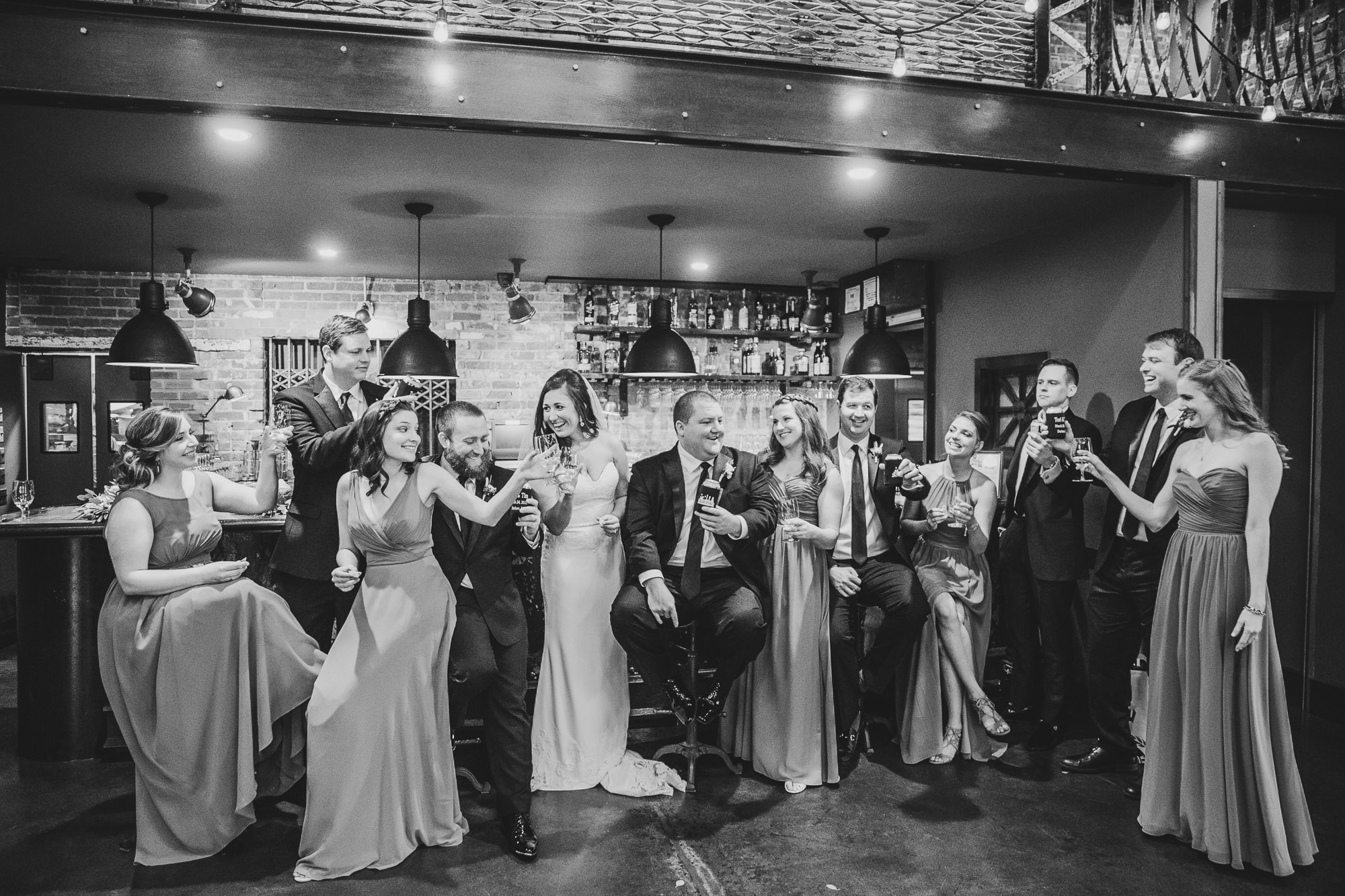 bridal party cheers in the bar at the cookery in durham