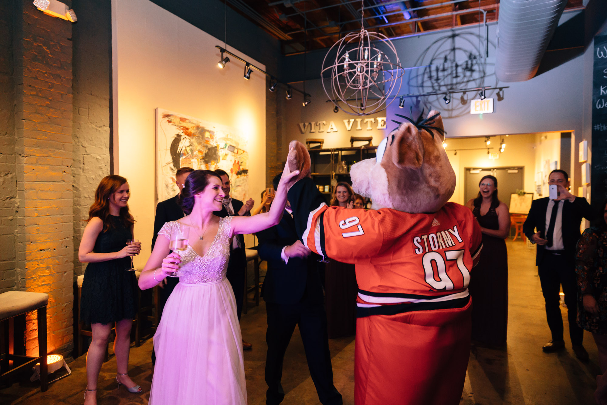 bride dancing with stormy the hurricanes mascot