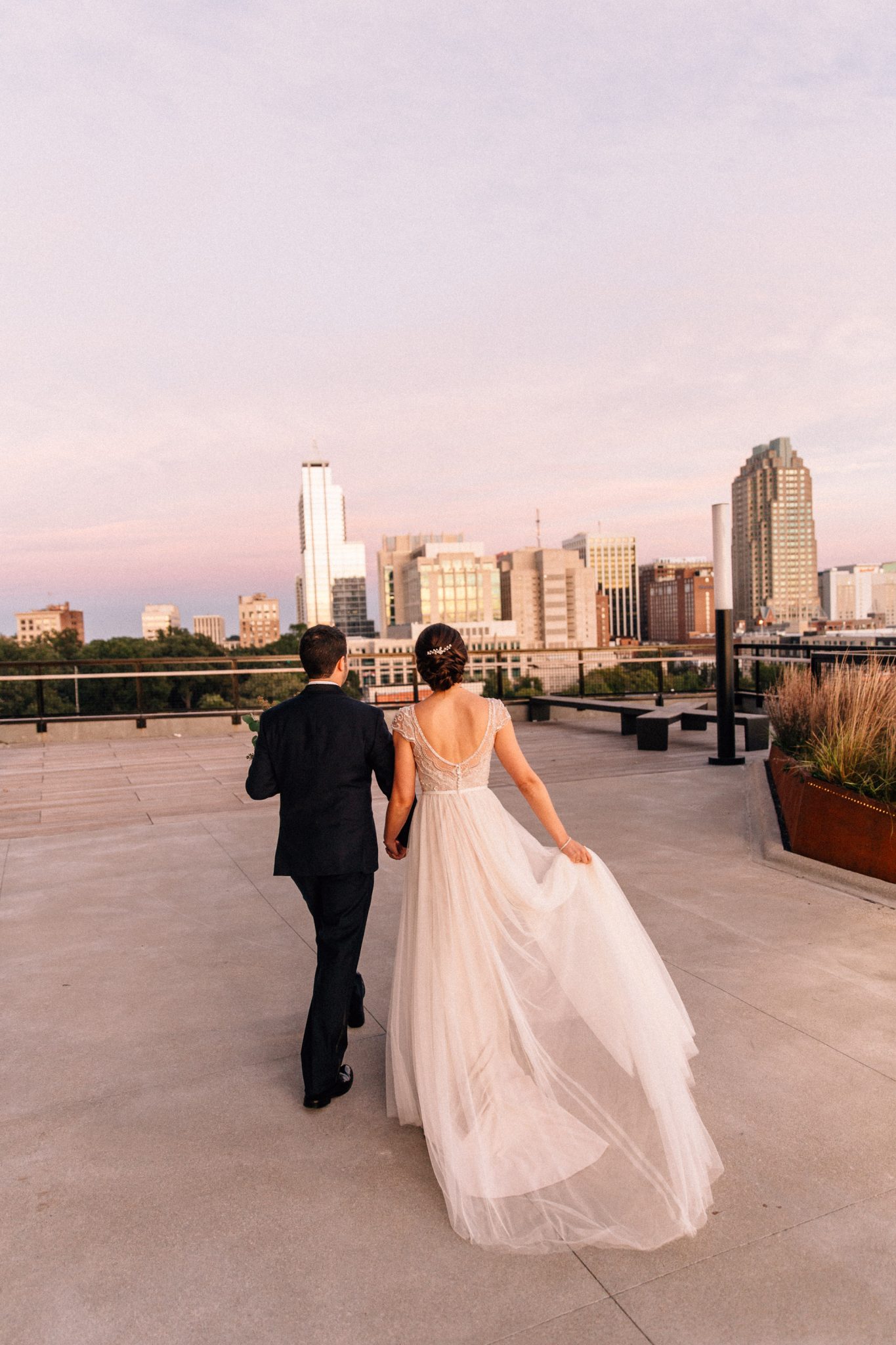 bride and groom on downtown raleigh rooftop